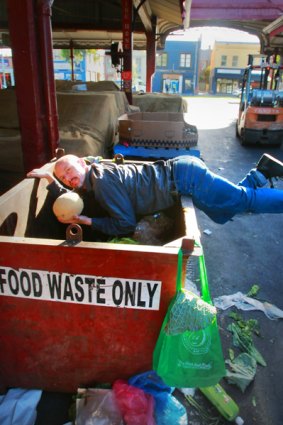 Freegan Tim Roberts salvages fruit and vegetables from a Queen Victoria Market skip.
