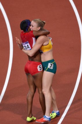 Sally Pearson and Kellie Wells hug after the race.