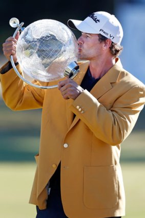 Scott kisses the trophy after winning the Australian Masters.