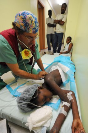 Mendji Bahina Sanon, 11, is checked by a doctor in a Port-au-Prince hospital.