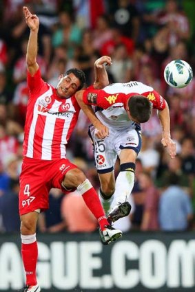 Head first: Adelaide's Tomi Juric (right) leads with his head against Simon Colosimo on Monday night.