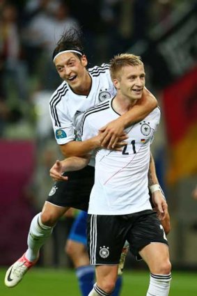 Marco Reus of Germany celebrates scoring their fourth goal with Mesut Ozil during the quarter final match in Gdansk, Poland.