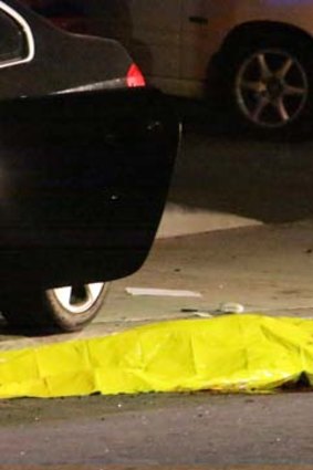 One of the nine crime scenes: A body is covered on the ground after a mass shooting near the campus of the University of California.