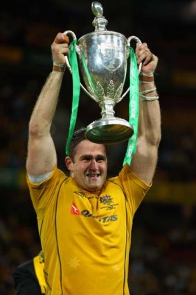 Wallabies captain James Horwill lifts the Tri-Nations trophy