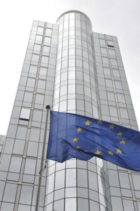 The European Union flag flies in front of the European Parliament in Brussels.