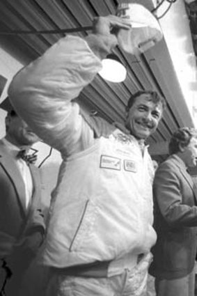 Brock on the podium after winning the 1987 race with Peter McLeod and David Parsons.