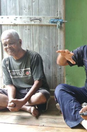 Related issue ...  Anwar Ibrahim, the leader of four villages around the Sayeng settlement, discusses climate change and the REDD scheme with his family.