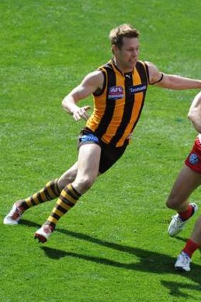 Hawthorn V Sydney Hawthorn's Sam Mitchell chases Sydney's Ryan O'Keefe.