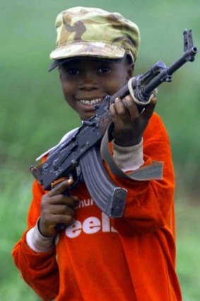 Weapon of choice: Abau, a nine-year-old soldier in Sierra Leone, waves his AK-47 assault rifle in this file photo from 2000.