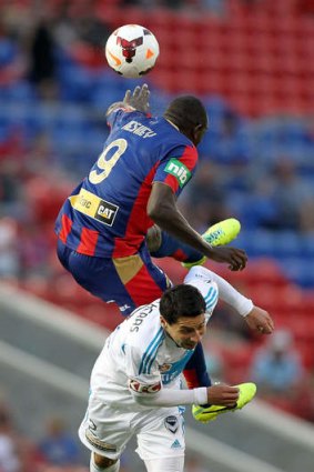 Double act: Newcastle's Emile Heskey heads over Pablo Contreras.