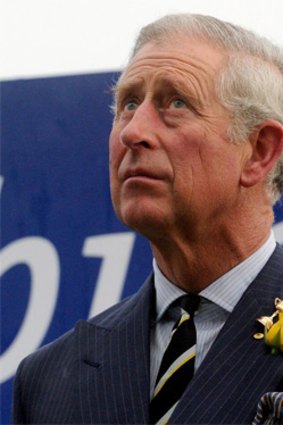 Prince Charles casts a wary eye to the sky.