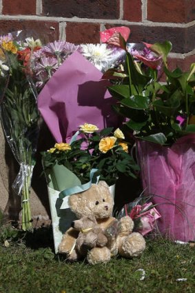Floral tributes and a teddy bear from well wishers are placed at the house of the al-Hilli family in Claygate, England.