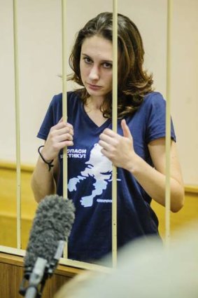 Greenpeace activist Alexandra Harris looks out from the defendant's cage during a hearing at the Primorskiy Court in St Petersburg.