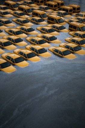 Taxis sit in a flooded lot in Hoboken, New Jersey.