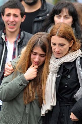Struggling to cope ... young people walk away from the Ozar Hatorah school in Toulouse.