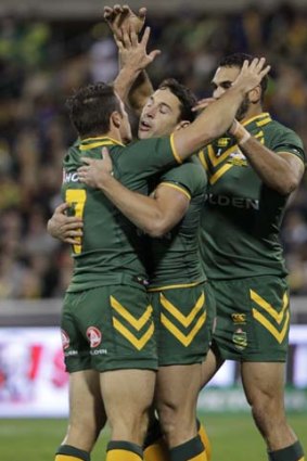 Top start: Australia's Cooper Cronk (left) is congratulated by Billy Slater and Greg Inglis after his try.