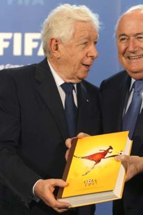 FFA chairman Frank Lowy submits Australia's official bid book for the 2018 or 2022 World Cups to FIFA president Sepp Blatter in Zurich on May 14, 2010.
