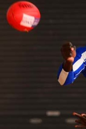 Majak Daw handballs during a North Melbourne recovery session at Aegis Park on Monday.