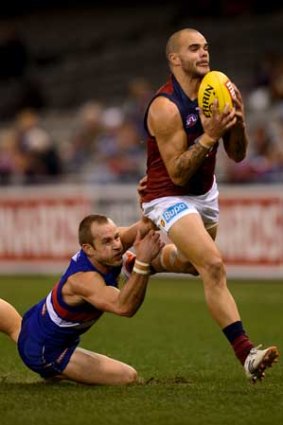 Brisbane's Ash McGrath's marks in front of Bulldogs' Daniel Cross.