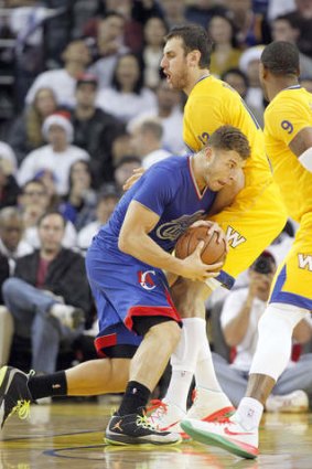 Out of my way: Blake Griffin charges into Andrew Bogut.