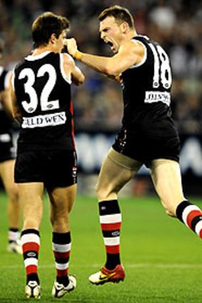 Andrew McQualter and Brendon Goddard celebrate beating the Cats.