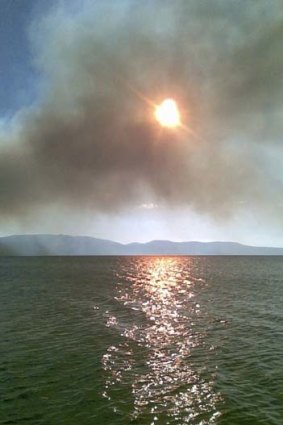 An out of control bushfire burning at the edge of Wallis Lake.