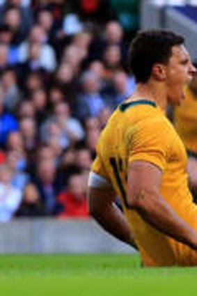 Real find: Matt Toomua celebrates after scoring the opening try for the Wallabies despite the tackle from Chris Robshaw.