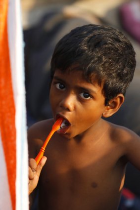 A Sri Lankan asylum seeker brushes his teeth on a boat at the Cilegon harbour in Indonesia's Banten province.