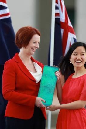 The Young Australian of the Year 2012, Marita Cheng, receives her award from Prime Minister Julia Gillard.