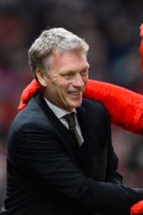 David Moyes shakes hands with Manchester United's mascot Fred the Red ahead of the match between United and Swansea City.