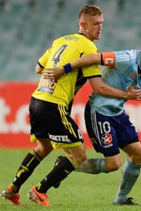 Alessandro Del Piero of Sydney is held back by Luke Adams of the Phoenix during the A-League match on Sunday.