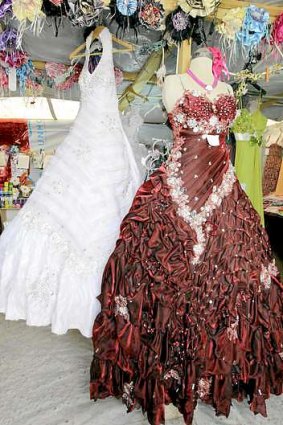 Wedding gowns hang in a covered stall in the Zaatari refugee camp.