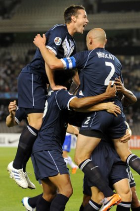 Melbourne Victory's Adrian Leijeris congratulated by teammates after scoring against Japan's Gamaba Osaka in their AFC Champions League Group E match in Melbourne.