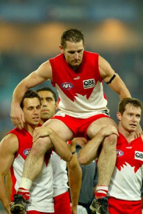 Daryn is carried off the field after his last game in 2003.