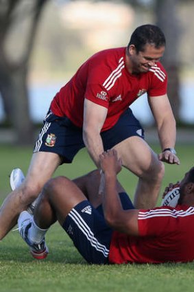 Still got it: Manu Tuilagi is tackled by defence coach Andy Farrell.