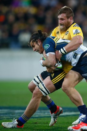 Matt Toomua of the Brumbies is tackled by Brad Shields of the Hurricanes on Saturday.
