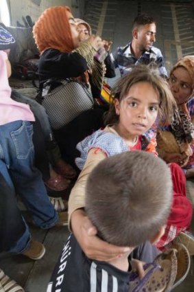 Women and children sit in a military helicopter after being evacuated by Iraqi forces from Amerli, north of Baghdad.