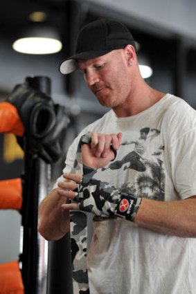 Barry Hall wraps his hands at FightFit Boxing Centre.