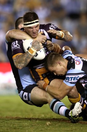 Josh McGuire of the Broncos is tackled.