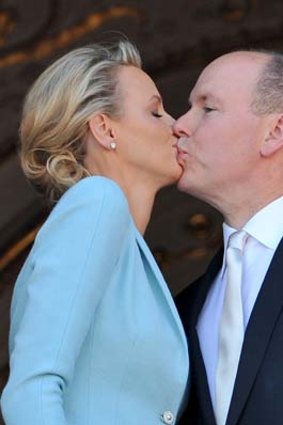 The couple share a kiss for the cameras.
