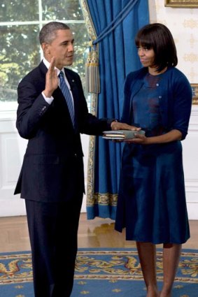 Michelle Obama sported a youthful new hairdo - but sedate dress - at yesterday's swearing-in ceremony.