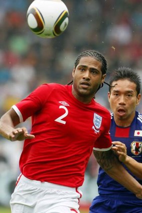 Glen Johnson of England, left, is challenged by Yuichi Komano of Japan.