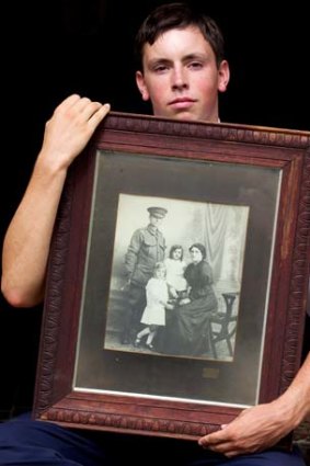 Family heartache: Angus Morris holds the portrait of his great, great grandparents Private John Crane and Catherine, and their daughters Jessie, 5, and Maisie, 2.