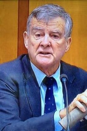Senator Bill Heffernan brandishes his "pipe bomb" inside Parliament House in 2012.