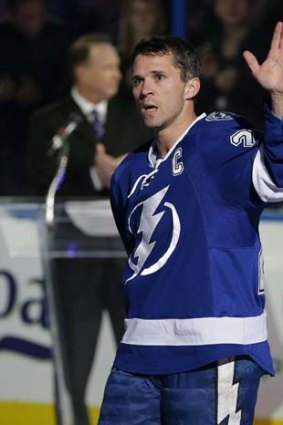 Tampa Bay Lightning right wing Martin St. Louis waves to the fans during a celebration of his 1,000th game, November 2013.