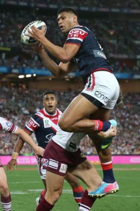Rising to the occasion: Daniel Tupou scores for the Roosters.