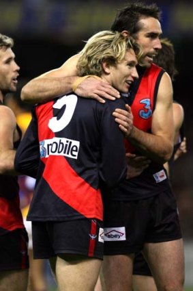 Mark McVeigh, Scott Lucas and James Hird celebrating a goal in their time together at Essendon.