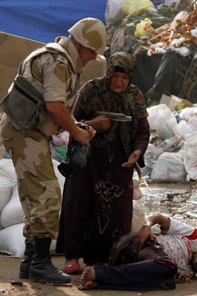 A soldier comes to assist her.