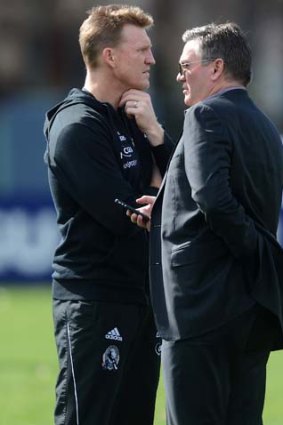 Collingwood president Eddie McGuire shares his thoughts with coach Nathan Buckley.