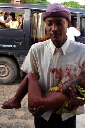 A victim of fighting between insurgents and government troops in Mogadishu is carried to hospital.